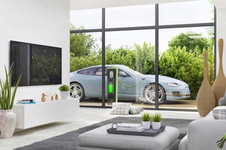 Blue-Porsche-Taycan-Charges-next-to-luxurious-house