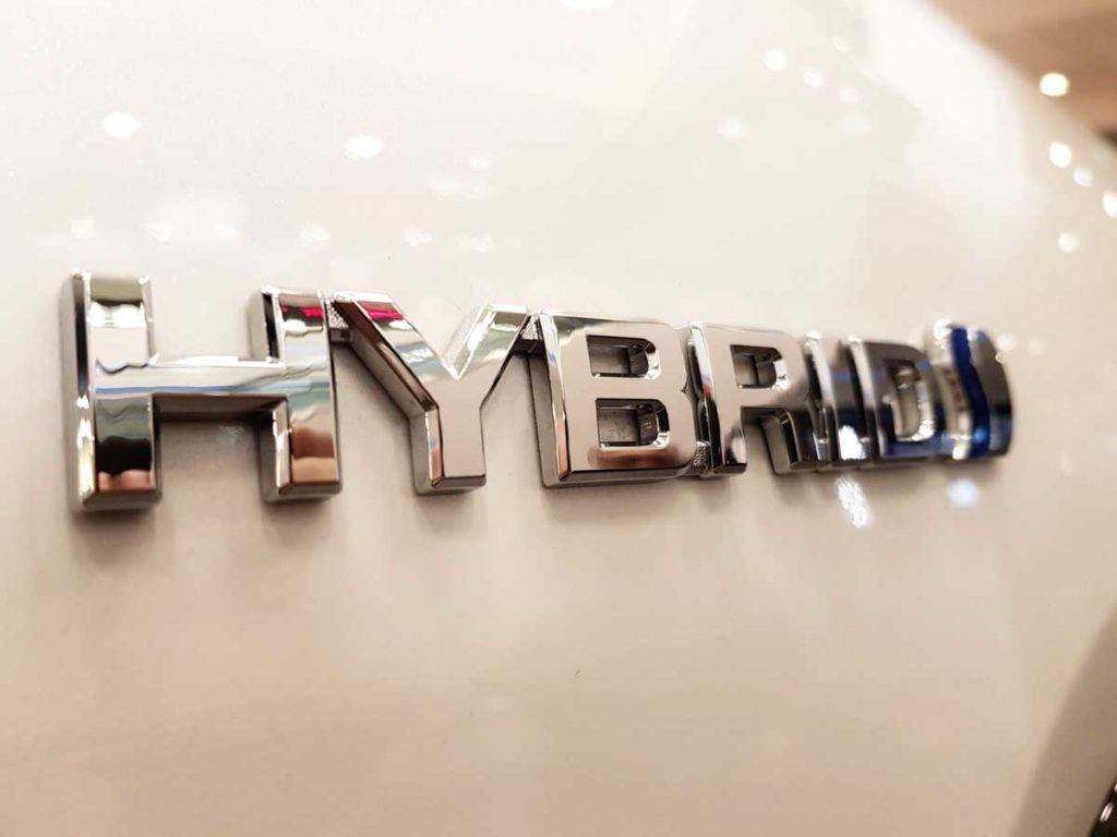 Hybrid Badge on White Vehicle