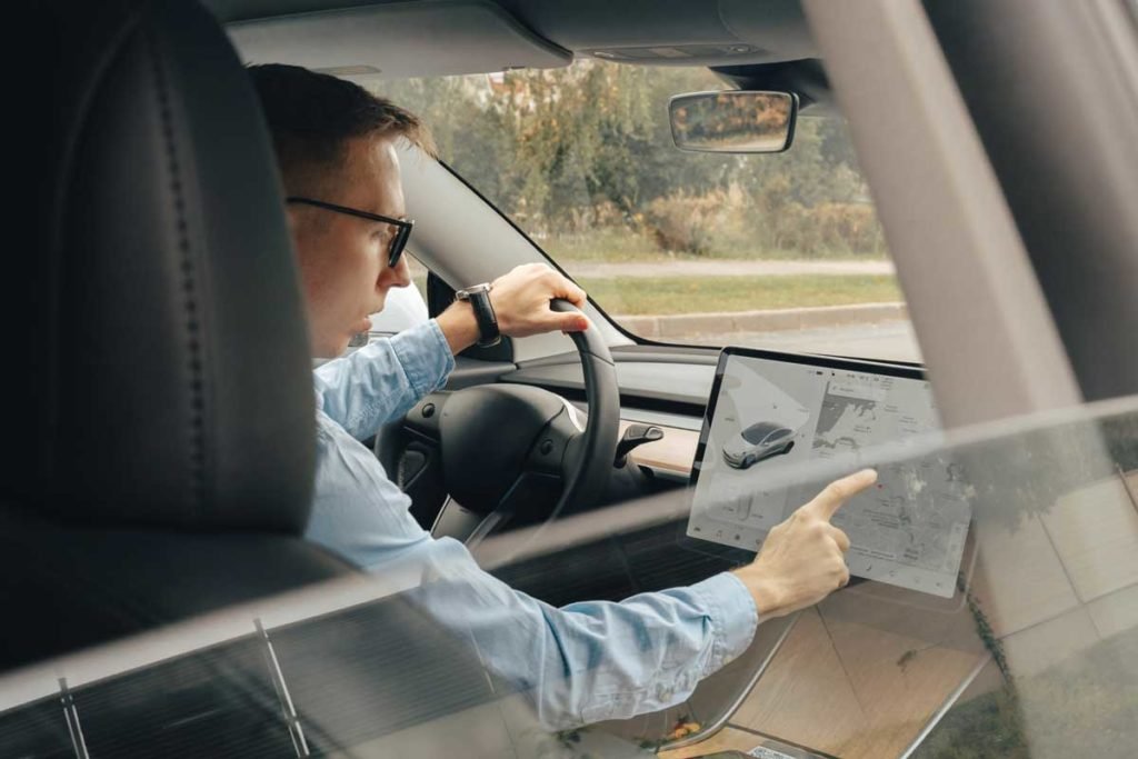 businessman-behind-the-wheel-of-tesla-car-innovation-technology-new-generation-electro-hybrid-vehicle_Tesla-Road-Trip